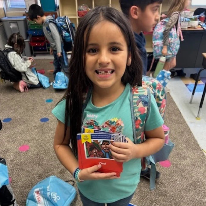 An opened Take-Everywhere Literacy Pack with sorted books.