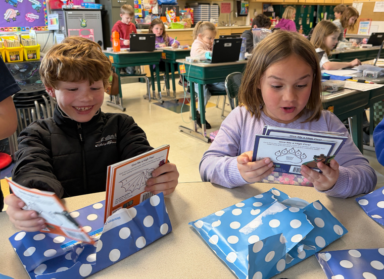 A family watching a short phonics video lesson opened from a QR code.