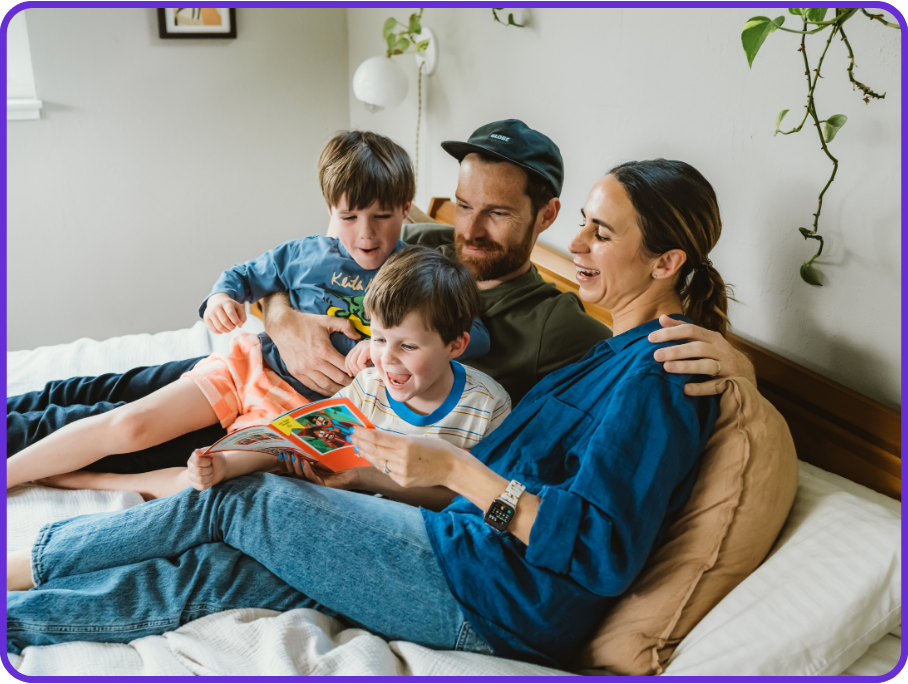 A family reading together at home using a video phonics lesson